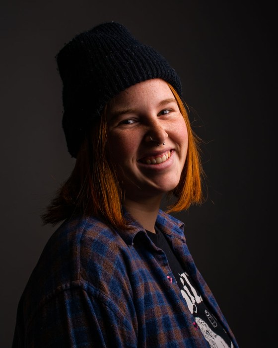 Studio portrait lit warmly from one side
